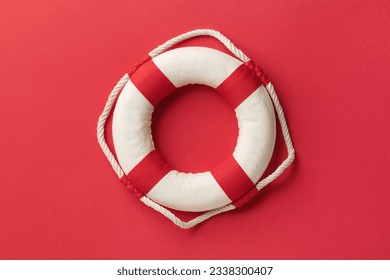 Lifebuoy on a red background, top view