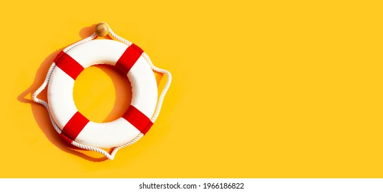 Lifebuoy on yellow background. Copy space