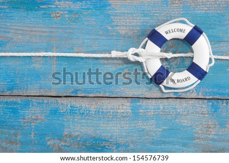 Lifebuoy tied with a rope - blue background for cruising