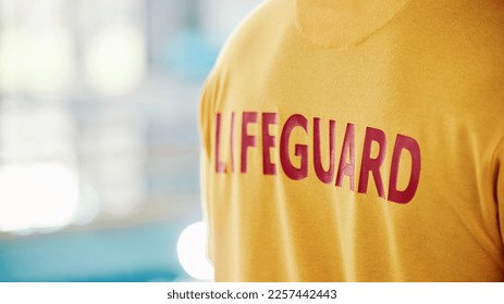 Lifeguard, closeup and swimming pool safety at indoor facility for training, swim and exercise. Pool, attendant and water sports person ready for danger, protection or diving athletics with mockup