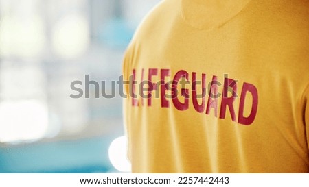 Lifeguard, closeup and swimming pool safety at indoor facility for training, swim and exercise. Pool, attendant and water sports person ready for danger, protection or diving athletics with mockup