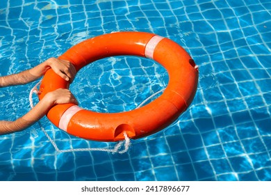 Lifeguard girl training with a life preserver swimming in the pool. - Powered by Shutterstock