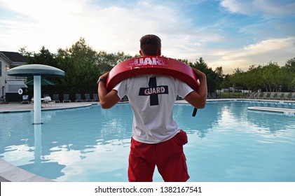 Lifeguard having fun at the pool while there are no visitors