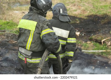 Lifeguard on duty. Firefighter puts out fire. Details of fire. Rescuer in Russia. Extinguishing fire in forest. - Powered by Shutterstock