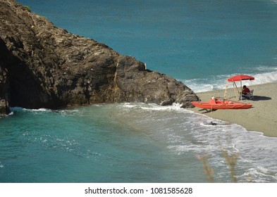 A Lifeguard Siting Next To The Monterosso Beach With His Kayak, CInque Terre, Italy.