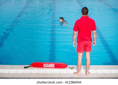 Lifeguard Standing By The Pool