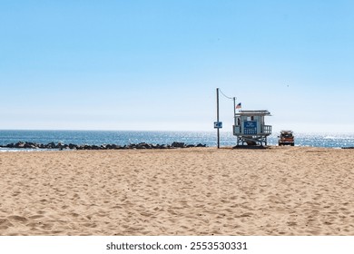 A lifeguard tower on a sandy beach in Los Angeles, with an ocean backdrop and sunny skies.
 - Powered by Shutterstock