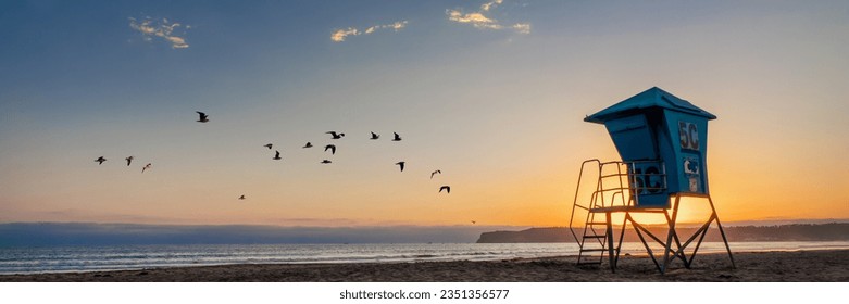 Lifeguard tower and seagulls on Coronado beach, panoramic sunset in San Diego, California - Powered by Shutterstock