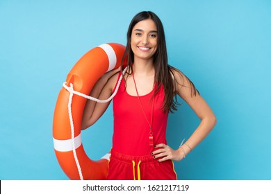 Lifeguard woman over isolated blue background with lifeguard equipment and with happy expression