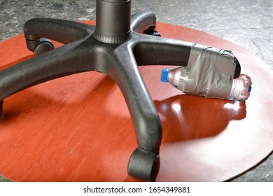 Lifehacks, Wrapping Water Bottle To Fix Broken Office Chair Close Up      
