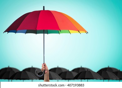 Life-health Insurance protection, business financial leadership concept with leader's hand holding rainbow umbrella distinctively unique