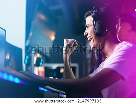 Lifes a game so level up. Shot of a young man cheering while playing computer games.