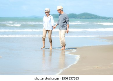 Lifestyle asian people senior couple walking happy and relax on the beach.  Tourism elderly family travel leisure and activity after retirement vacations and summer. - Powered by Shutterstock