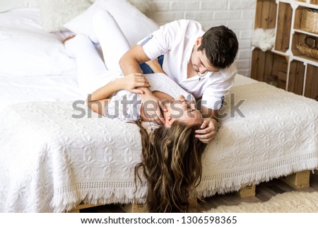 Similar – Beautiful woman looking to man lying on bed