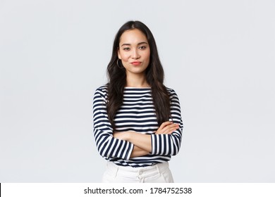 Lifestyle, Beauty And Fashion, People Emotions Concept. Skeptical And Judgemental Asian Female Office Manager Looking Picky, Smirk And Pouting Dissatisfied, Cross Arms Chest