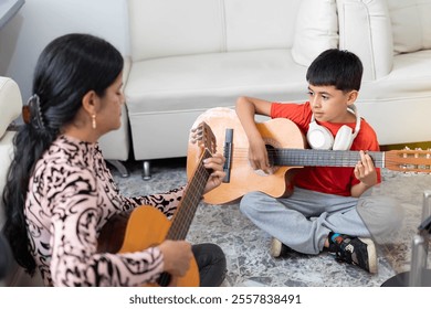 Lifestyle: Boy learning to play acoustic guitar at home - Powered by Shutterstock