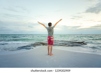 Lifestyle Of Boy Show Hands Up At The Beach Tell The World Of Freedom On The Wide Sea. Summer Vacation, Liberation And Freedom In The Concept.