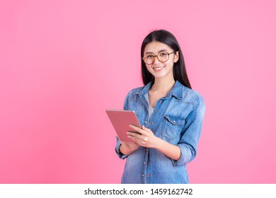 lifestyle business people Beautiful cute girl Asian woman holding a smart phone tablet computer on pink background - Powered by Shutterstock