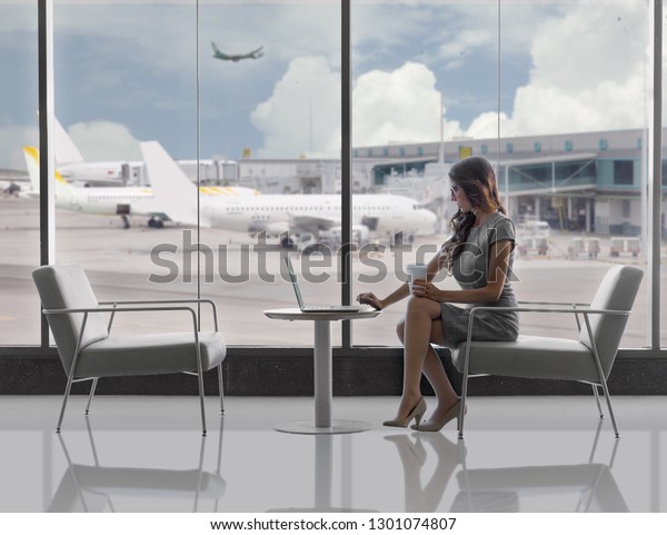 Lifestyle business woman,\
executive traveller working on laptop in airport terminal, with\
copy space