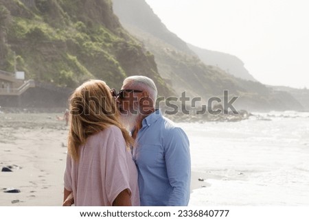 lifestyle of caucasian senior couple kissing on beach, happy in love romantic and relax time, tourism of elderly family pleople, leisure and activity travel after retirement in vacations and summer