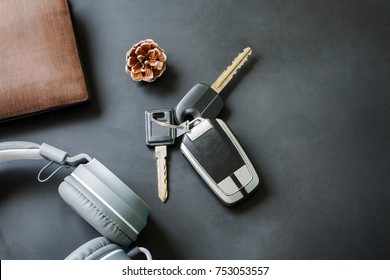 Lifestyle changes of your with stopped work and get out travelling relaxing searching for freedom. above view key car and headphone music and wallet on black table. copy space used for add messages. - Powered by Shutterstock