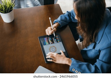 Lifestyle creative hobby woman digital artist draws a digital picture on digital tablet at cafe shop, Asian female artist illustrator painting drawing on touch pad digital tablet with stylus pen - Powered by Shutterstock