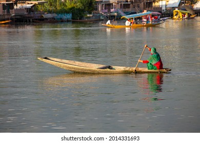 Lifestyle in Dal lake, local people use Shikara, a small boat for transportation in the lake of Srinagar, Jammu and Kashmir state, India. Indian woman on a boat