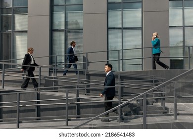 Lifestyle Of Diverse Businesspeople Walking Upstairs Downstairs. Business People Outside Office In The City After Work. Business Concept 