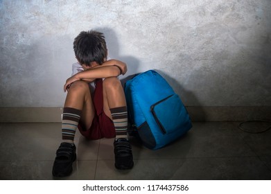 Lifestyle Dramatic Bullying Victim Portrait Of Young Sad Scared Kid 8 Years Old In School Uniform And Backpack Sitting Alone Crying Depressed And Frightened Suffering Abuse Problem Being Bullied