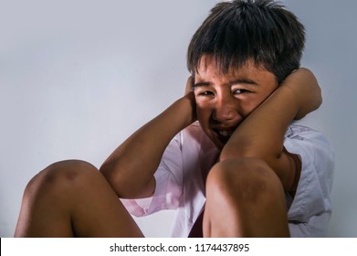 Lifestyle Dramatic Bullying Victim Portrait Of Young Sad And Scared Kid 7 - 10 Years Old In School Uniform Sitting Alone Crying Depressed And Frightened Suffering Abuse Problem Helpless And Bullied