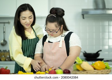 Lifestyle Family Relationship Daughter Disability Learning. Young Girl At Classroom Kitchen Learning