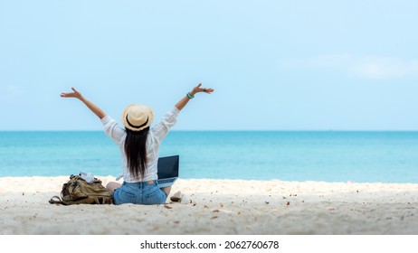 Lifestyle freelance woman using laptop working and relax on the beach.  Asian people success and together your work pastime and meeting conference on internet in holiday. Business and Summer Concept - Shutterstock ID 2062760678