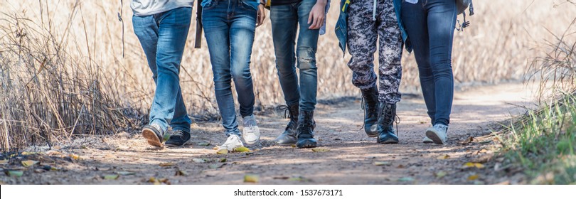 Lifestyle Group Of People With Shoes Walking The Forest While Travelling On Vacation.