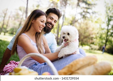 Lifestyle, Happy Couple Resting At A Picnic In The Park With A Dog