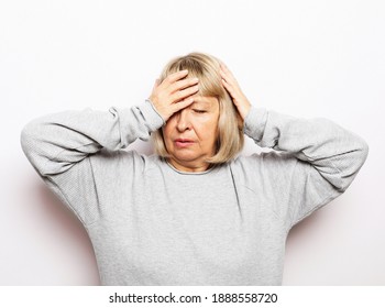 Lifestyle, Health And Old People Concept: Beautiful Mature Woman Touching Her Head Having A Headache, On White Background