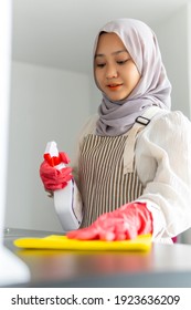 Lifestyle at home, cute malay woman doing housework by cleaning the kitchen