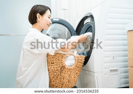 Lifestyle image of a young woman doing laundry