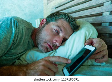 Lifestyle Indoors Portrait Of Young Internet Addict Man Sleeping On Home Couch Holding Mobile Phone In His Hand In Smartphone And Social Media Overuse And Online Addiction And Obsession Concept