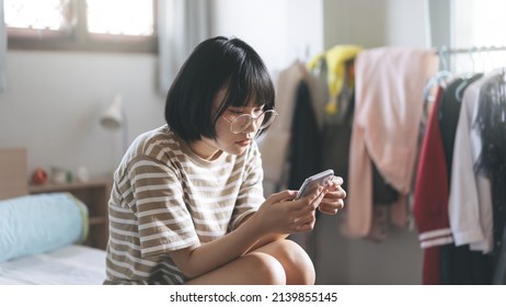 Lifestyle With Modern Technology Concept. Happy Young Adult Lonely Single Woman Holding Smartphone In The Moring For Telemedicine And Mental Health Concept.