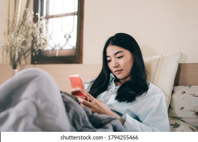 Lifestyle With Modern Technology Concept. Young Adult Lonely Single Woman Using Smartphone In The Moring For Social Message App Chat With Friend For Mental Health.