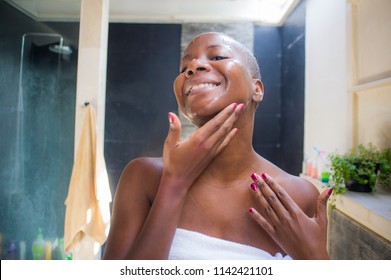 Lifestyle Natural Portrait Of Young Attractive And Happy Black Afro American Woman At Home Bathroom Looking On Toilet Mirror Applying Face Beauty Moisturizer Gel Smiling Fresh And Cheerful