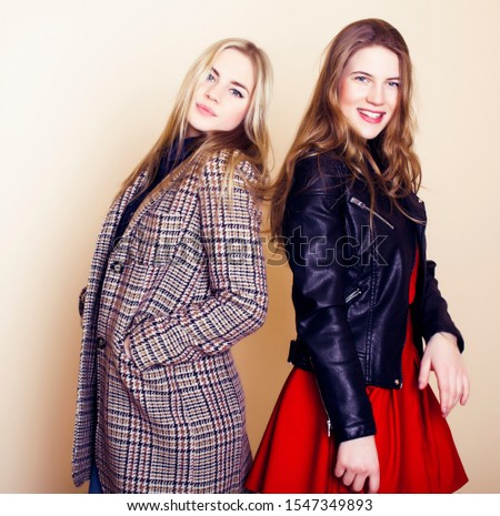 lifestyle and people concept: Fashion portrait of two stylish girls best friends, over white background. Happy time for fun