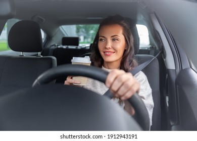 Lifestyle And People Concept - Happy Smiling Young Woman Or Female Driver Driving Car And Drinking Takeaway Coffee