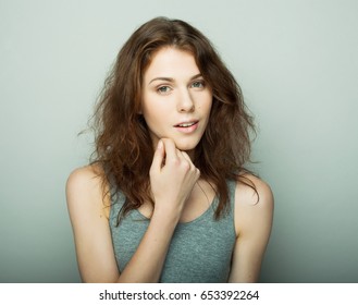 lifestyle and people concept: Young casual woman portrait. Clean face, curly hair. 