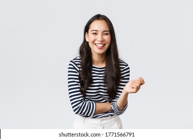 Lifestyle, People Emotions And Casual Concept. Carefree Happy Outgoing Asian Woman Having Fun Talking To People, Laughing And Smiling Upbeat, Standing White Background Cheerful