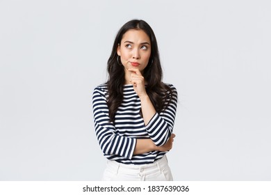 Lifestyle, people emotions and casual concept. Thoughtful troubled businesswoman thinking. Girl searching solution looking up pondering, making difficult choice - Powered by Shutterstock