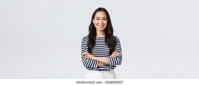 Lifestyle, people emotions and casual concept. Confident nice smiling asian woman cross arms chest confident, ready to help, listening to coworkers, taking part conversation - Powered by Shutterstock