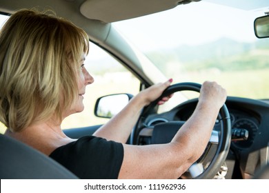 Lifestyle Photo Of Attractive Mature Woman Driving Car