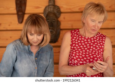 Lifestyle Photo Portrait Of Two Women 55 Years Old Doing Their Own Thing