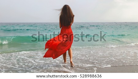 lifestyle photo of woman with perfect hair.walking alone at the beach.Sensual young girl relaxing.Colorful filter.glam style,teen trend outfit, positive mood,smiling,amazing model girl,long hair